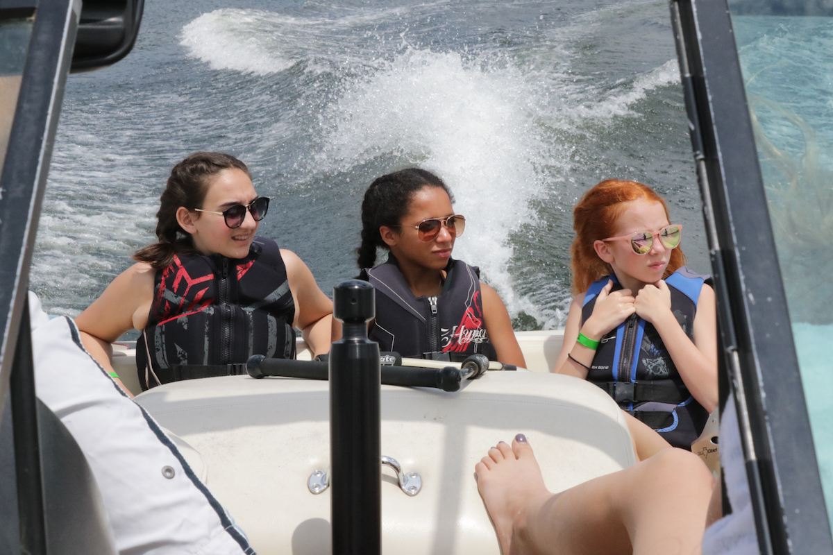 Campers on a boat at Pine Ridge